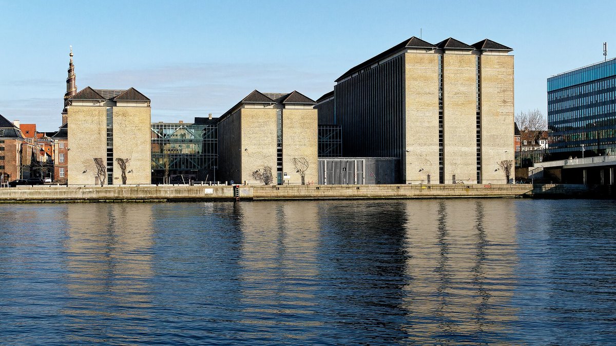 Udenrigsministeriets lyse pakhusbygninger på Asiatisk Plads set fra den anden side af havnen i klart vejr